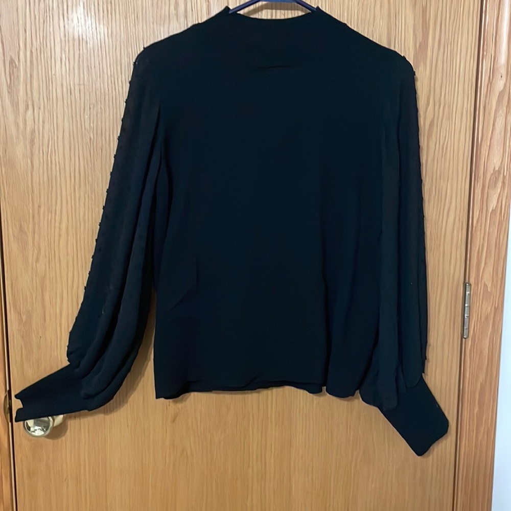 Black sweater with polka dot sheer sleeves